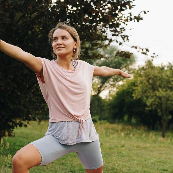 Smiling person in a relaxed stretching pose after a workout, feeling refreshed and calm.